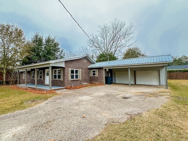 ranch-style house featuring a front lawn, a porch, and a garage