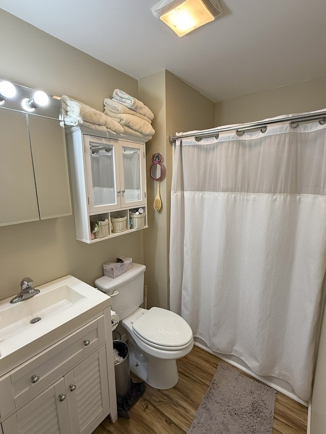 bathroom featuring vanity, a shower with curtain, wood-type flooring, and toilet