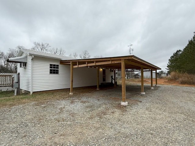 view of parking / parking lot featuring a carport