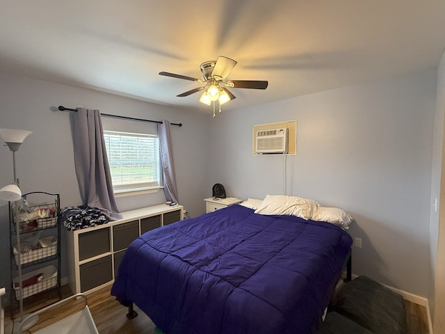 bedroom featuring ceiling fan, an AC wall unit, and dark hardwood / wood-style flooring