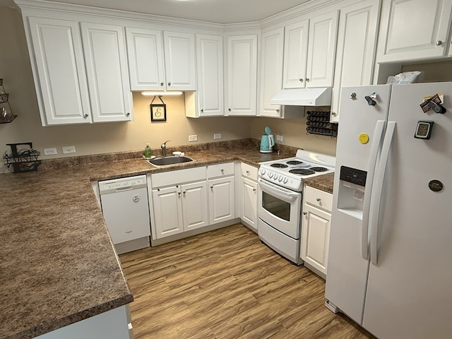 kitchen with white cabinetry, white appliances, light hardwood / wood-style floors, and sink