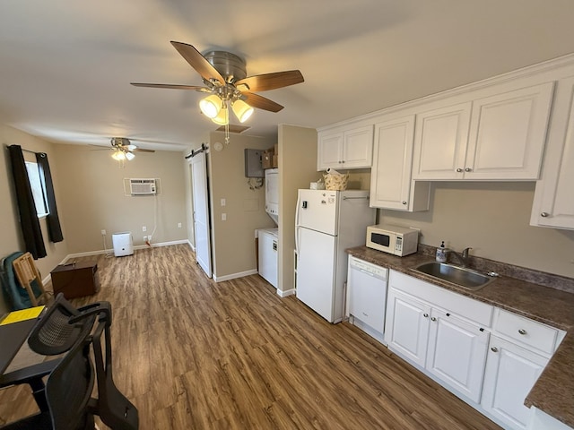 kitchen featuring sink, white appliances, a wall unit AC, and white cabinets