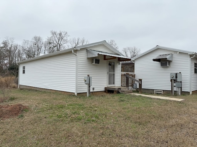 rear view of house featuring a lawn