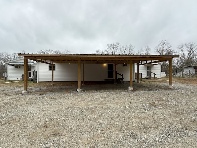 rear view of property featuring a carport