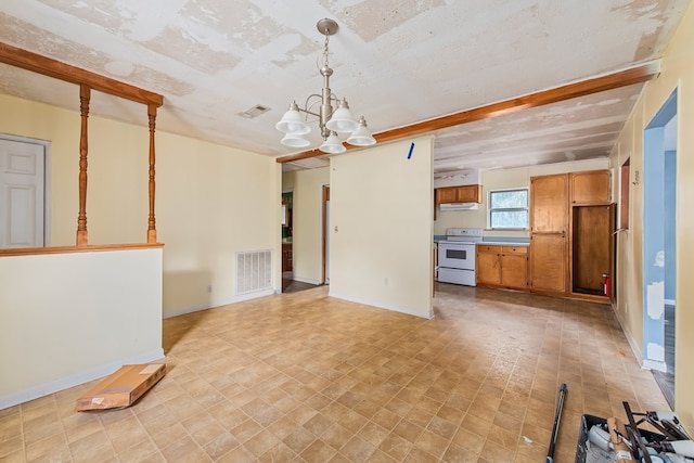 unfurnished living room with a textured ceiling and a notable chandelier