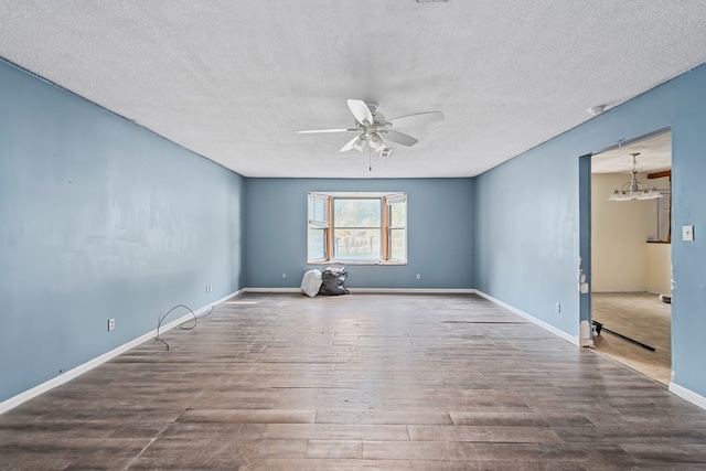 unfurnished room featuring hardwood / wood-style floors, a textured ceiling, and ceiling fan