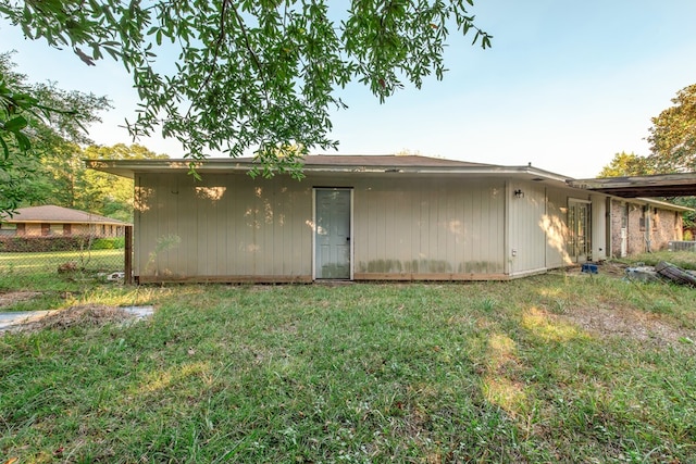 rear view of house featuring a yard