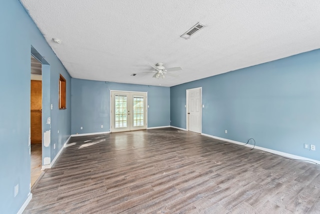 spare room featuring french doors, ceiling fan, hardwood / wood-style floors, and a textured ceiling