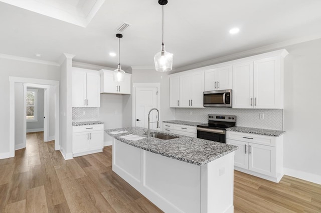 kitchen featuring white cabinetry, sink, light stone counters, and stainless steel appliances