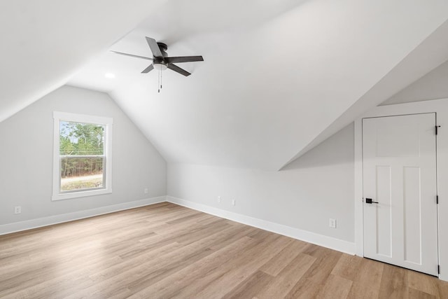 additional living space featuring vaulted ceiling, light hardwood / wood-style floors, and ceiling fan