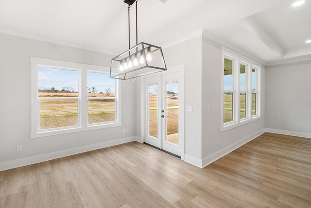 unfurnished dining area featuring light hardwood / wood-style flooring and ornamental molding