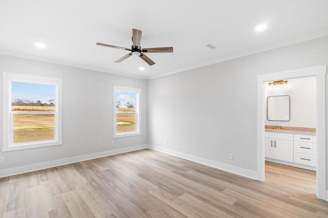 spare room featuring ornamental molding, ceiling fan, and light wood-type flooring