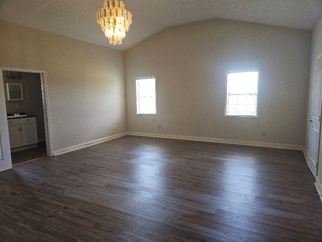 901 Grove St, Cottonwood, AL 36320 - spare room with a chandelier, lofted ceiling, and dark wood-type flooring