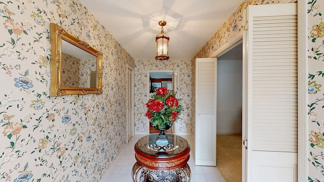 hall featuring light tile patterned flooring