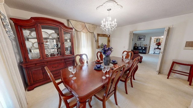 carpeted dining room featuring a chandelier and a textured ceiling