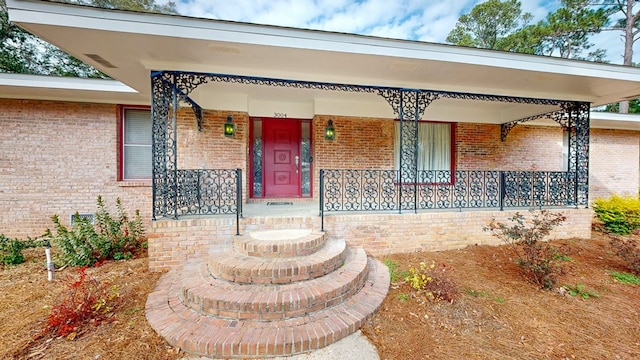 doorway to property featuring a porch