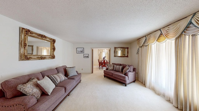 living room with light carpet and a textured ceiling