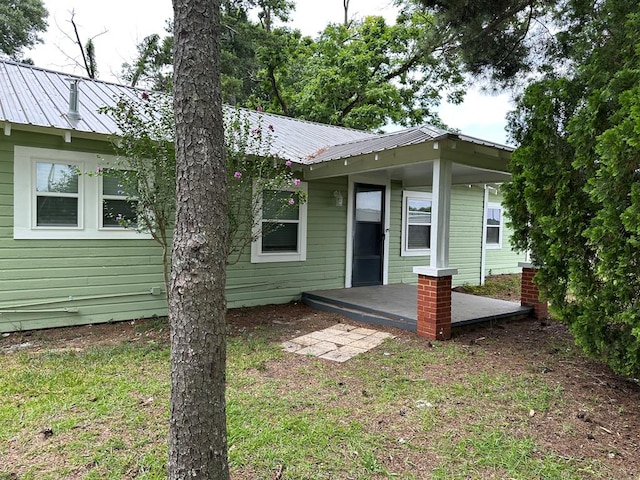 back of property featuring a lawn