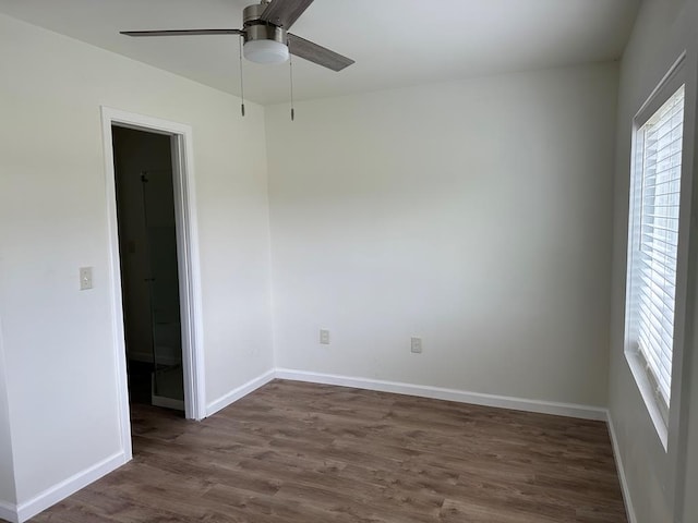 unfurnished room with dark hardwood / wood-style floors and ceiling fan