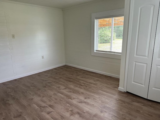 empty room featuring hardwood / wood-style floors and ornamental molding