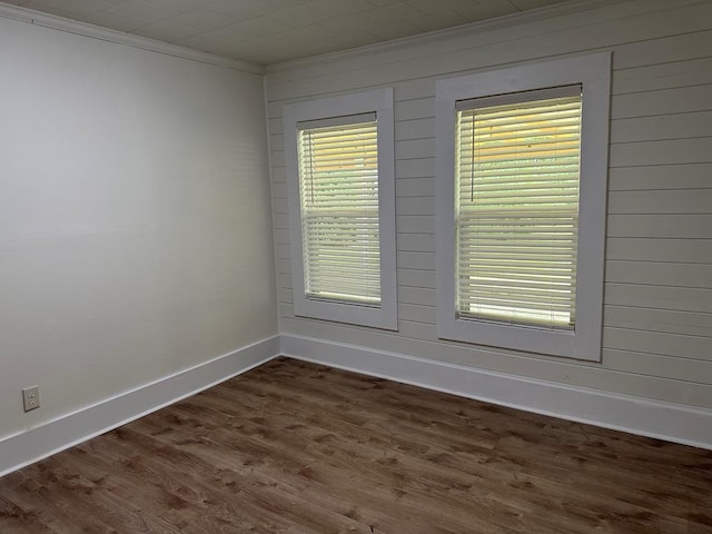 spare room with crown molding and dark hardwood / wood-style flooring