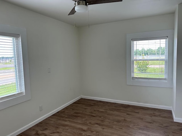 empty room with dark hardwood / wood-style floors and ceiling fan