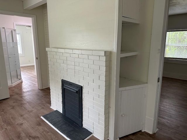 room details featuring wood-type flooring and a brick fireplace