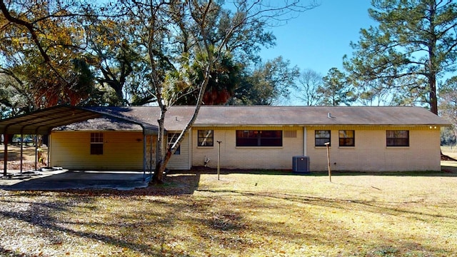 back of property featuring brick siding and a lawn