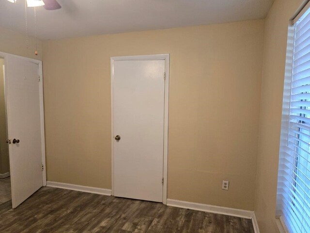 826 Old Newton Rd, Daleville, AL 36322 - unfurnished bedroom featuring dark wood-style floors, baseboards, and a ceiling fan