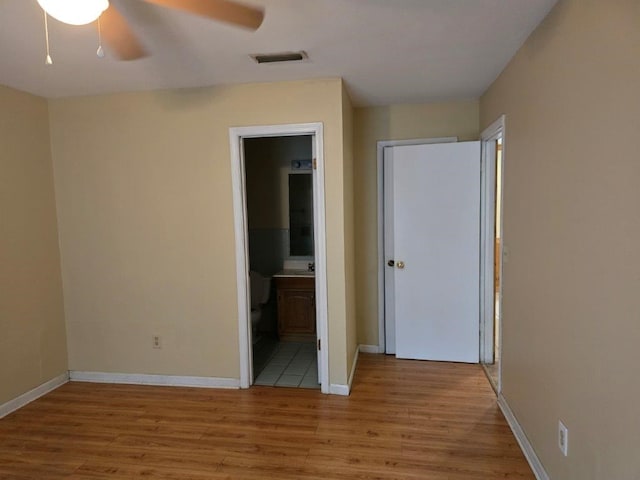 826 Old Newton Rd, Daleville, AL 36322 - unfurnished bedroom featuring light wood finished floors, baseboards, ensuite bath, and ceiling fan