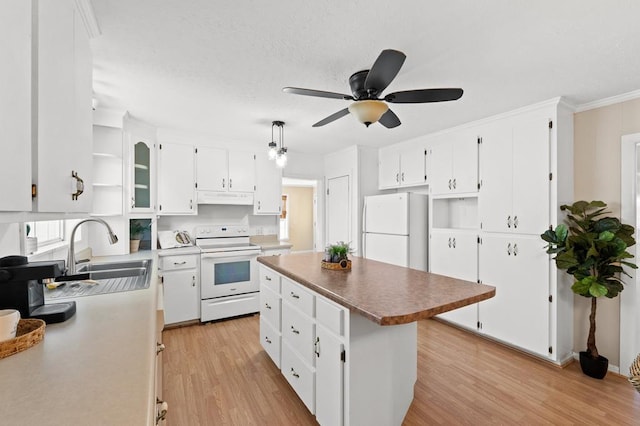 kitchen featuring white cabinets, white appliances, light hardwood / wood-style floors, and a kitchen island