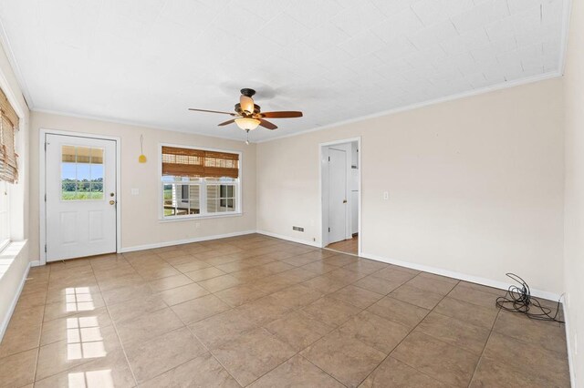 empty room featuring light tile patterned floors, ceiling fan, and crown molding