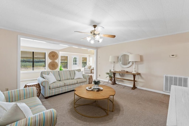 living room with crown molding, visible vents, and carpet flooring