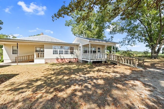 back of house featuring covered porch