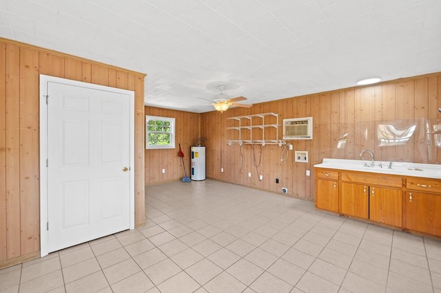 interior space featuring a ceiling fan, an AC wall unit, electric water heater, a sink, and light tile patterned flooring