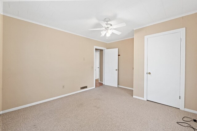 unfurnished bedroom with ceiling fan, carpet floors, and ornamental molding