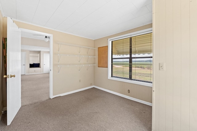 unfurnished room with carpet and baseboards