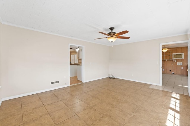 empty room with ornamental molding, a wall unit AC, ceiling fan, and baseboards