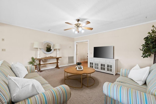 carpeted living room featuring ceiling fan and ornamental molding