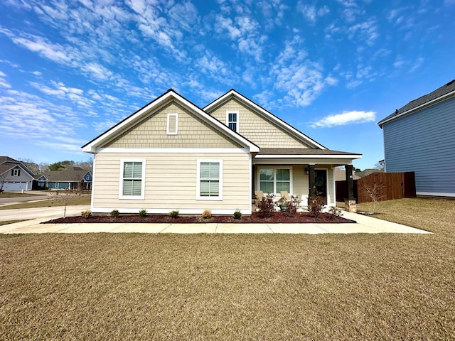 craftsman inspired home with a front lawn