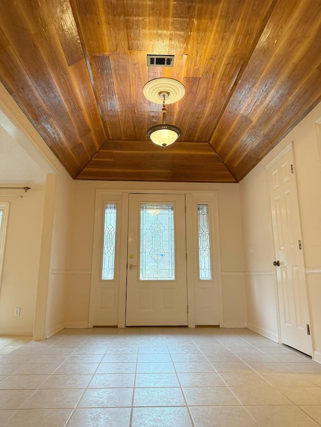 foyer featuring lofted ceiling, wooden ceiling, visible vents, and light tile patterned flooring