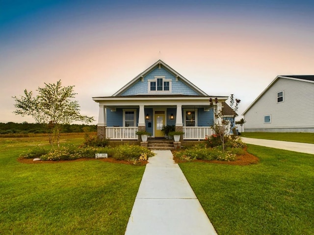 view of front facade with a yard and a porch