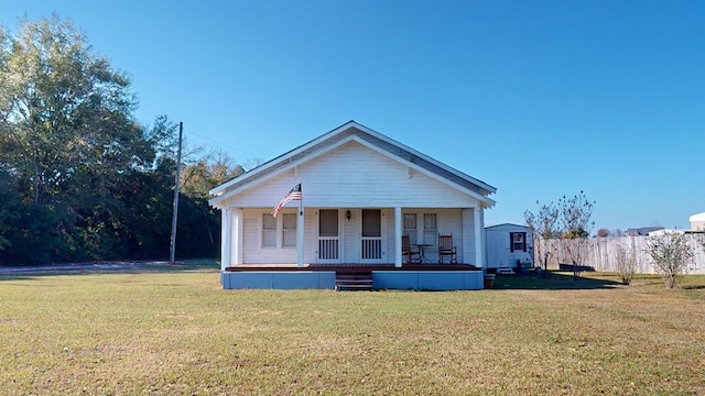 view of front of house featuring covered porch and a front lawn