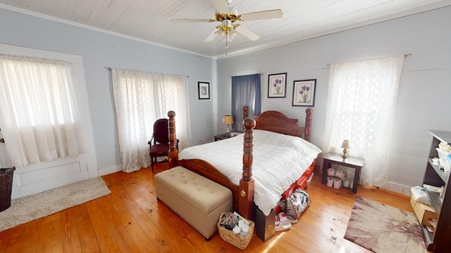 bedroom with light wood finished floors, baseboards, a ceiling fan, wood ceiling, and ornamental molding