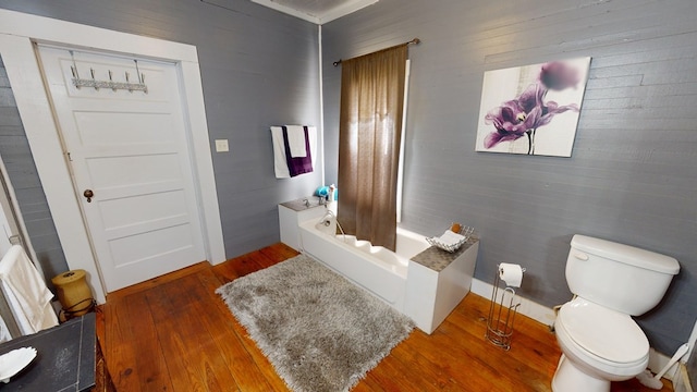 full bathroom featuring shower / bath combination with curtain, wood finished floors, and toilet