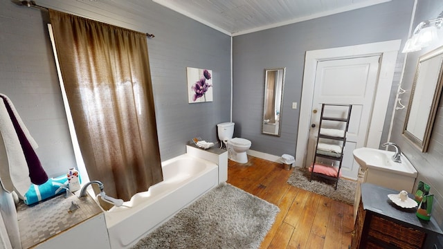 full bathroom featuring toilet, vanity, baseboards, hardwood / wood-style floors, and shower / bath combo