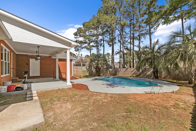 view of swimming pool with a ceiling fan, a patio, a fenced backyard, a yard, and a fenced in pool