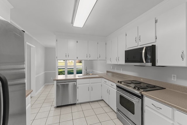 kitchen with light tile patterned floors, white cabinets, stainless steel appliances, and a sink