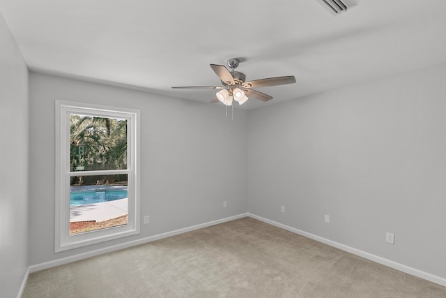 unfurnished room featuring visible vents, carpet flooring, a ceiling fan, and baseboards