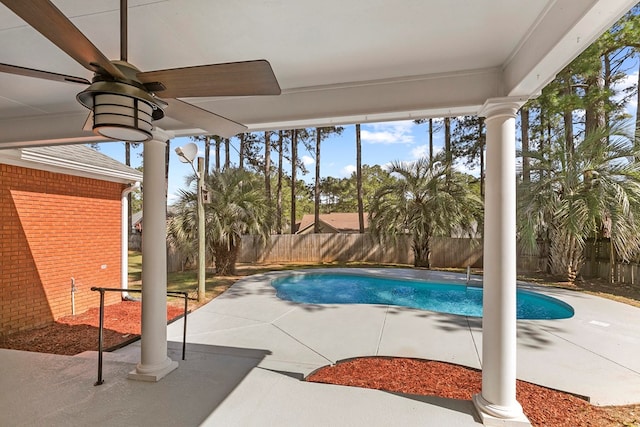 view of pool with a fenced in pool, a fenced backyard, a ceiling fan, and a patio area